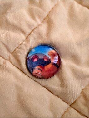 Pokemon Button Pin in Tan with Blue and Red Accents